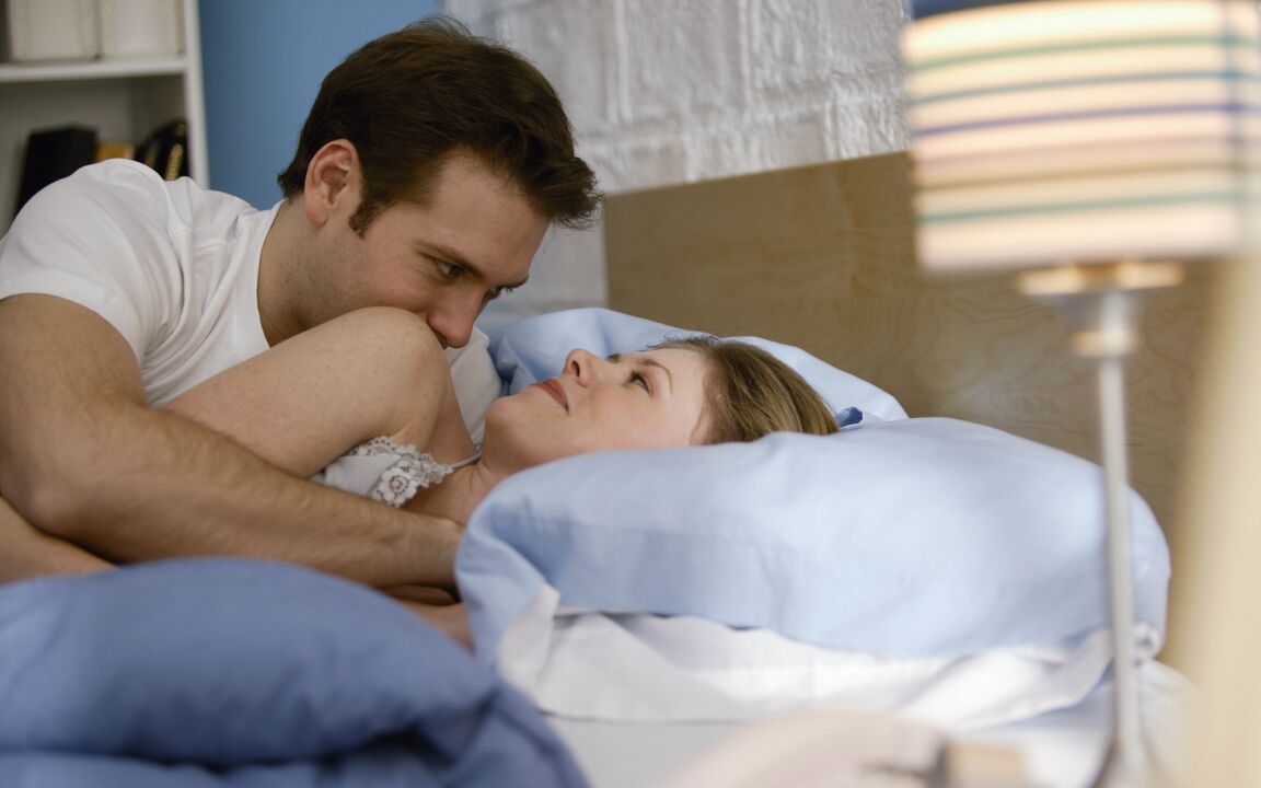 Woman in bed with a man with penis enlargement